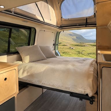 The made-up bed inside the camper.