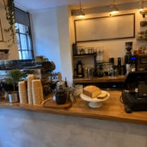 A wider shot of the café counter the cake sits on.